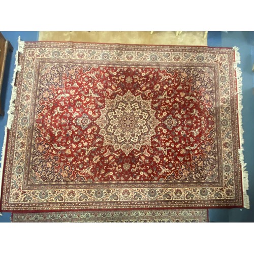 395 - An eastern wool rug, worked with central motif on a red ground within cream and red guard stripes, a... 