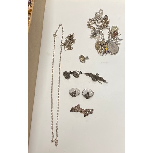 39 - A charm bracelet with several silver and other charms, silver shell earrings and other silver and co... 