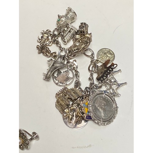 39 - A charm bracelet with several silver and other charms, silver shell earrings and other silver and co... 