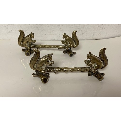 43 - A pair of silver plated knife rests, each with squirrel supports -