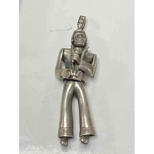 54 - A modern silver articulated Elvis Presley pendant, boxed -
