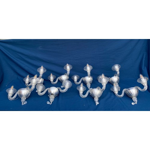 403 - A glass four branch chandelier, together with 8 matching twin branch wall lights (one a/f) each piec... 