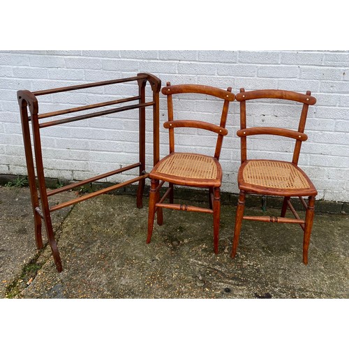 414 - A pair of cane seated chairs, together with a towel rail -
