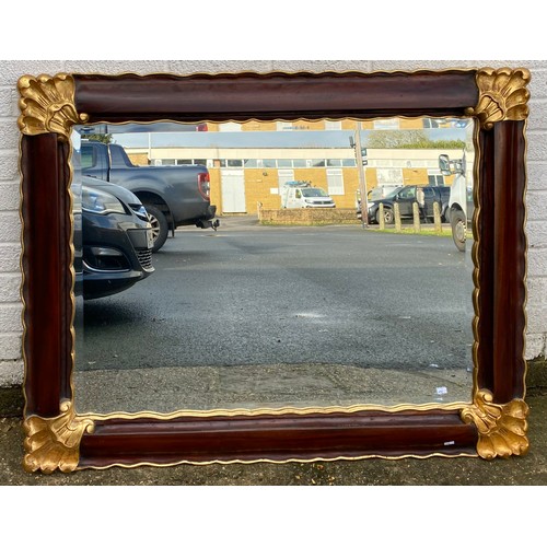 433 - A modern wall mirror, with gilded corners -