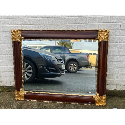 433 - A modern wall mirror, with gilded corners -