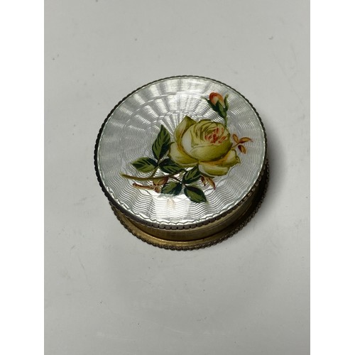 A George V silver and enamel pill box, Mappin Bros, Birmingham 1912, with floral and guilloche enamel to cover and gilded interior -