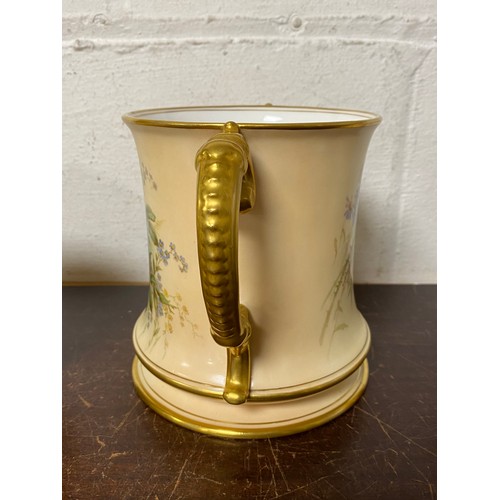 240 - A large Royal Worcester two handled loving cup, painted with flowers on a blush ground, with gilded ... 