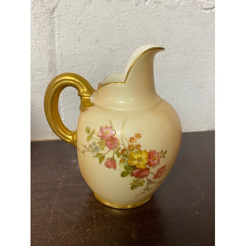 240 - A large Royal Worcester two handled loving cup, painted with flowers on a blush ground, with gilded ... 