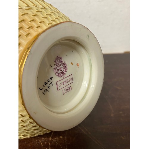 240 - A large Royal Worcester two handled loving cup, painted with flowers on a blush ground, with gilded ... 