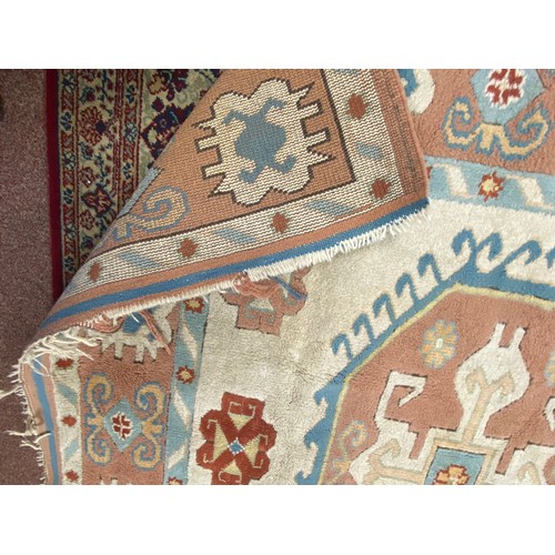439 - A large Turkish wool carpet, worked in peach and cream approximately, 230 x 170 cm -