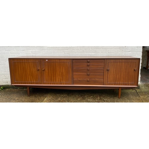 440 - A vintage teak sideboard, fitted with a pair of cupboard doors, five graduated drawers and a pull do... 