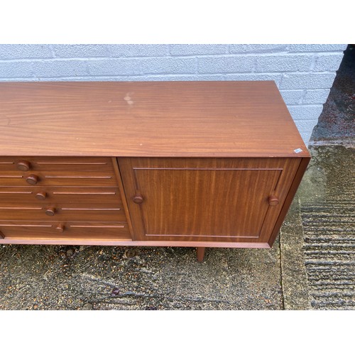 440 - A vintage teak sideboard, fitted with a pair of cupboard doors, five graduated drawers and a pull do... 