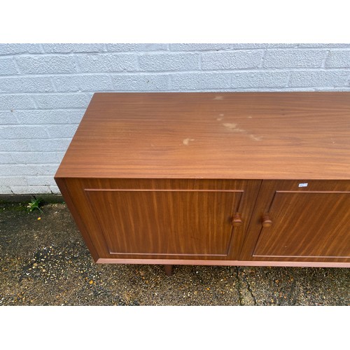 440 - A vintage teak sideboard, fitted with a pair of cupboard doors, five graduated drawers and a pull do... 