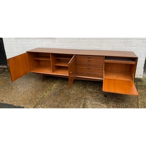 440 - A vintage teak sideboard, fitted with a pair of cupboard doors, five graduated drawers and a pull do... 