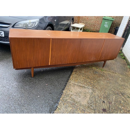 440 - A vintage teak sideboard, fitted with a pair of cupboard doors, five graduated drawers and a pull do... 