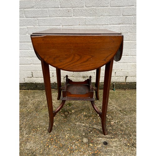 457 - An occasional table with four drop sides and undertier -