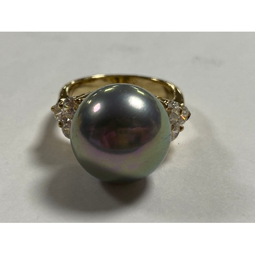 179 - A modern silver gilt dress ring set with a faux pearl between CZ -