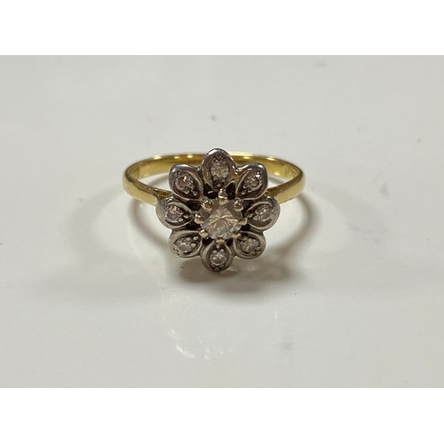 180 - A diamond cluster ring, of flowerhead design, set in 18ct gold -