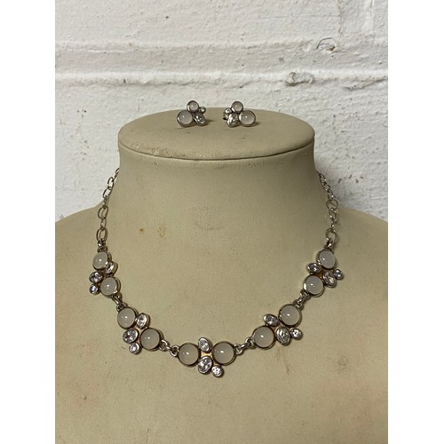 72 - A silver necklace and earring suite, each piece set with cabochon moonstones and clear white stones ... 