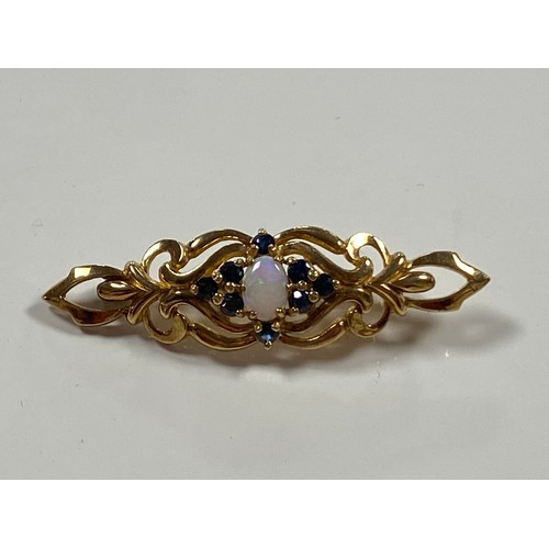127 - A 9ct gold brooch, of openwork design, set to the centre with an opal and sapphire cluster -