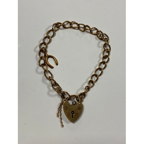 132 - A 9ct gold charm bracelet with heart shaped padlock clasp -