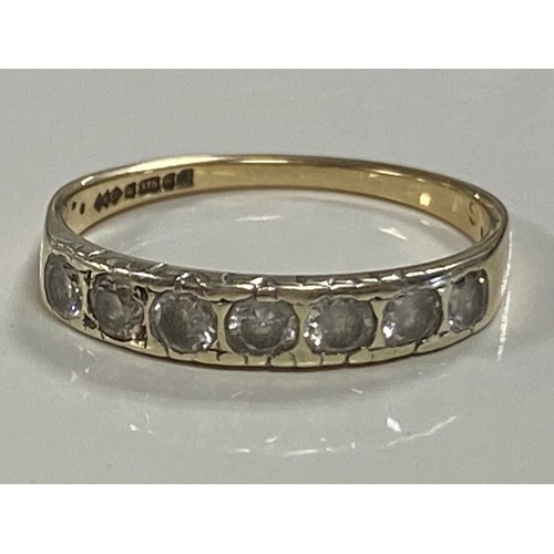 12 - A half eternity band, the seven circular white stones, set in 9ct gold -