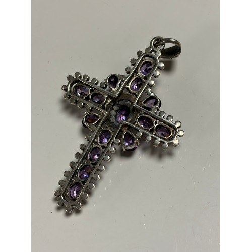 18 - A silver cross pendant, stamped 925, set with amethysts -