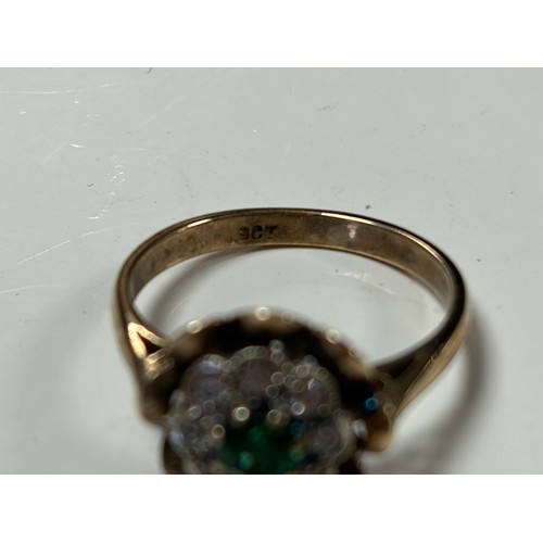 24 - A 9ct gold dress ring, set with a green and clear stone cluster -