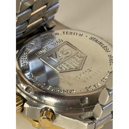 27 - A Tag Heuer Chronograph wristwatch, with white dial and bi-coloured bezel and strap, boxed with pape... 