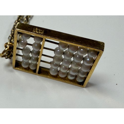 29 - A seed pearl set abacus pendant, in 14ct gold, to ropetwist chain, also stamped 14k -