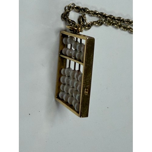 29 - A seed pearl set abacus pendant, in 14ct gold, to ropetwist chain, also stamped 14k -