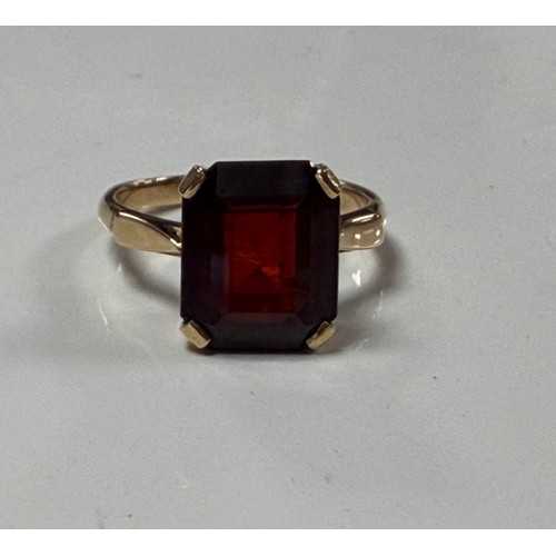 32 - A garnet single stone ring, the rectangular stone claw set in yellow metal mount, stamped 14k and 58... 