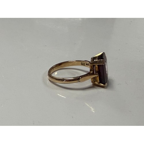 32 - A garnet single stone ring, the rectangular stone claw set in yellow metal mount, stamped 14k and 58... 