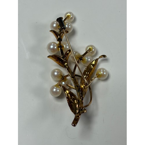 33 - A cultured pearl set brooch, of floral design, stamped 14k -
