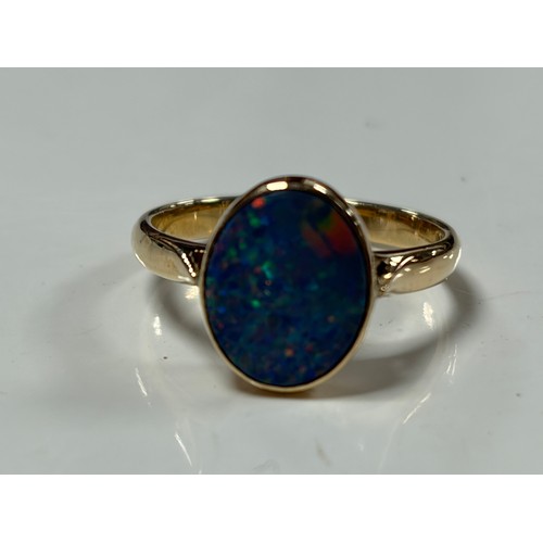 35 - A 14ct gold dress ring, set with a black opal doublet, stamped 585 -