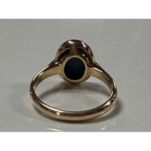 35 - A 14ct gold dress ring, set with a black opal doublet, stamped 585 -