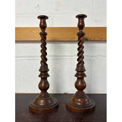 121 - A pair of carved barleytwist candlesticks -