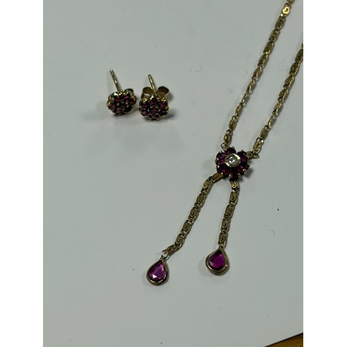 7 - A 9ct gold necklace, with a ruby and diamond cluster suspending two pear shaped rubies and a pair of... 