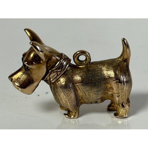 8 - A 9ct gold dog charm, with red paste set eyes -