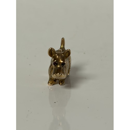 8 - A 9ct gold dog charm, with red paste set eyes -