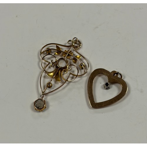 24 - An Art Nouveau gold and gem set pendant, set in an openwork design in 9ct gold and a 9ct gold heart ... 