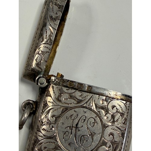 28 - A group of four vestas, to include a silver example and a plated example inset with dice -
