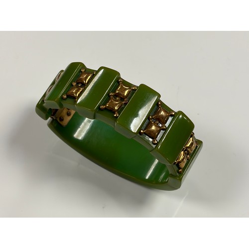 41 - A green bakelite and brass panel bracelet, together with other bakelite and plastic jewellery -