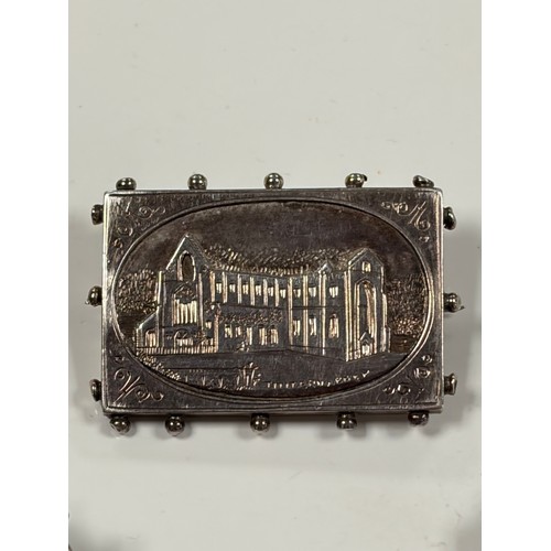 52 - A silver souvenir 'Tintern Abbey' brooch, together with two silver Mitzpah brooches, etc -