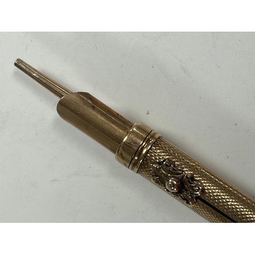 58 - A yellow metal propelling pen/pencil -
