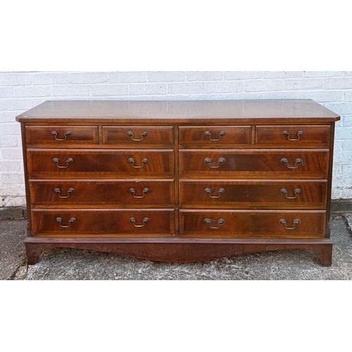 A reproduction mahogany finish double chest of drawers, on bracket feet -