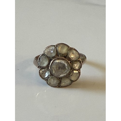 24 - A Georgian cluster ring, set with foiled back rose cut diamonds, to yellow metal mount (one stone de... 
