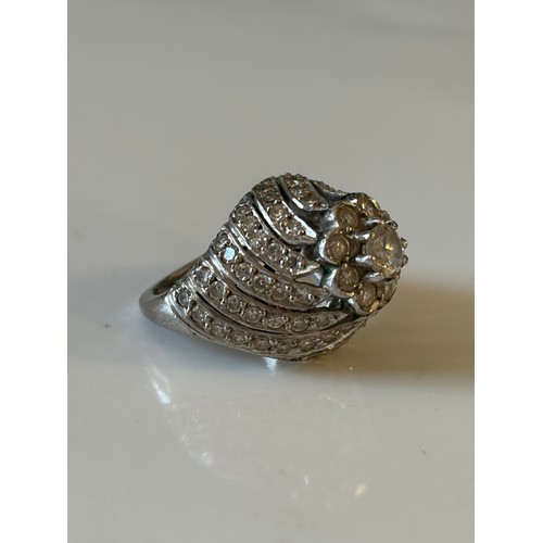 25 - A diamond set dress ring, of tiered flowerhead design, the central cluster to pierced diamond set mo... 