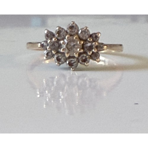 8 - A CZ dress ring, set with an oval cluster in 14ct gold mount -