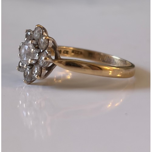 9 - A CZ dress ring, set with a flowerhead cluster in 14ct gold mount -